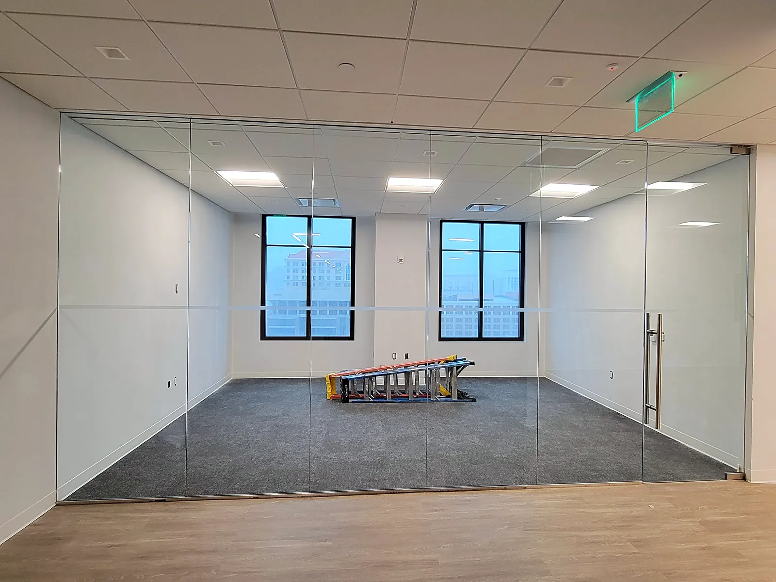 A glass-fronted office room we filmed, seen from the hallway